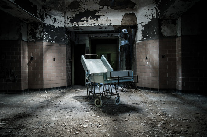 A Dark and Deserted Asylum Sits Quietly Falling to Pieces