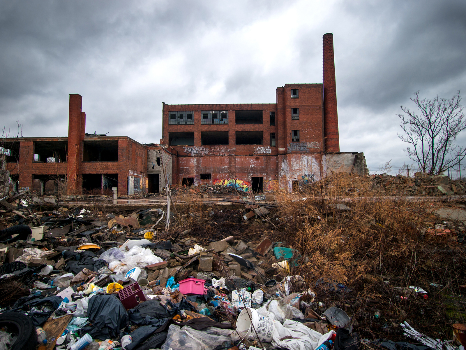 abandoned victoreen factory with pile of trash in front