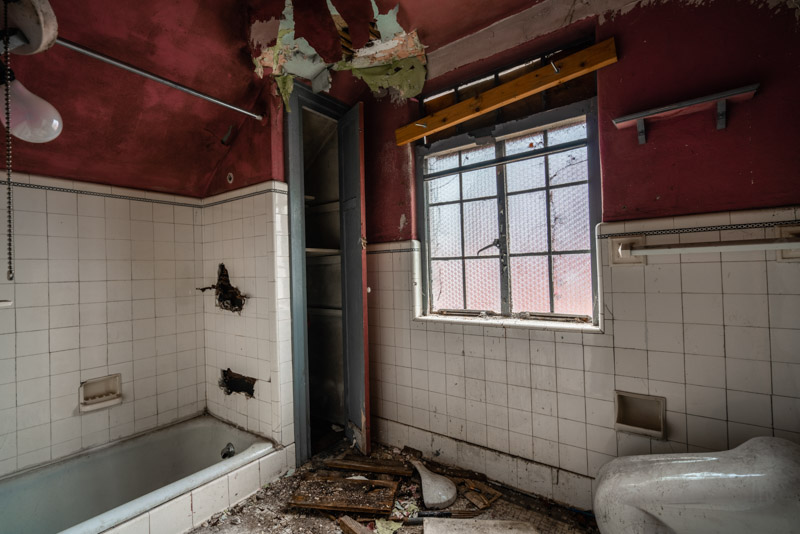 abandoned stucco home bathroom