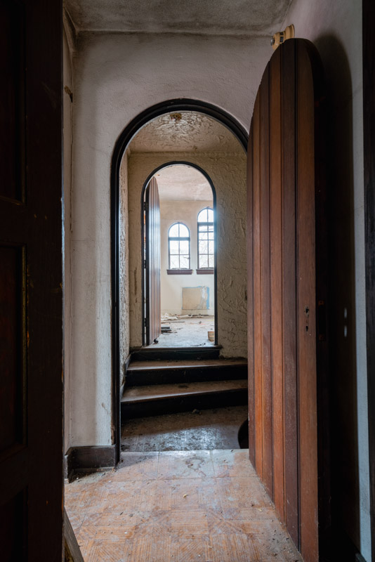 abandoned stucco home arched doorways