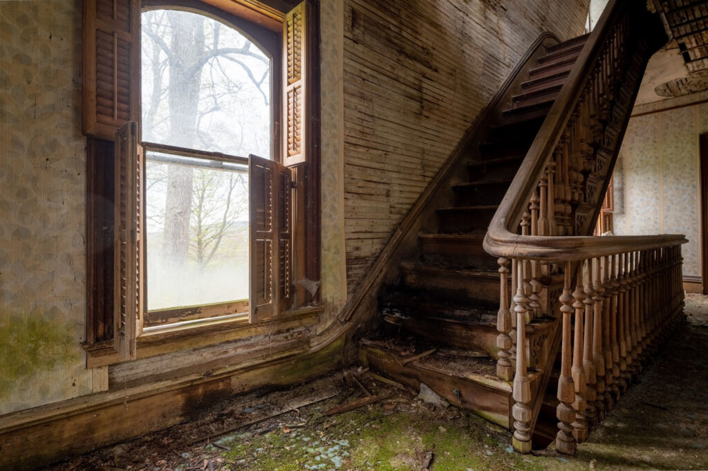 stairwell inside abandoned victorian home
