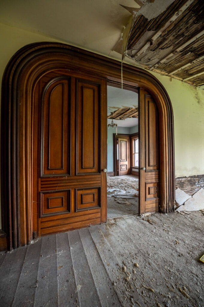 large doors inside abandoned victorian home